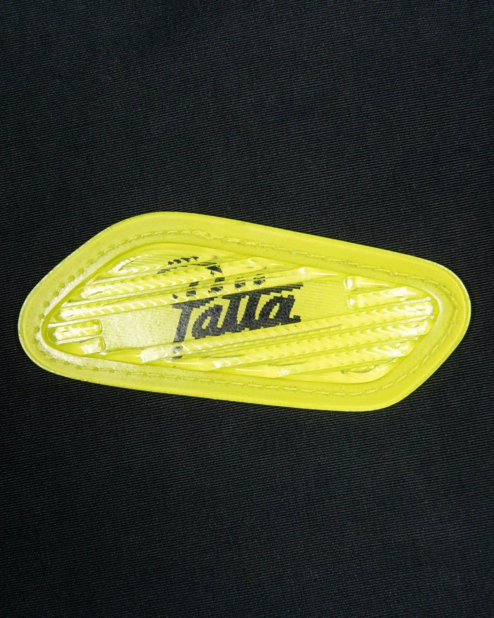 Cyber yellow lenticular Air Max badge detail on the black Patta x Nike NRG Track Jacket.